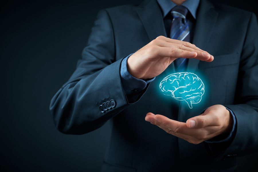 Man holding a cartoon blue brain between his hands